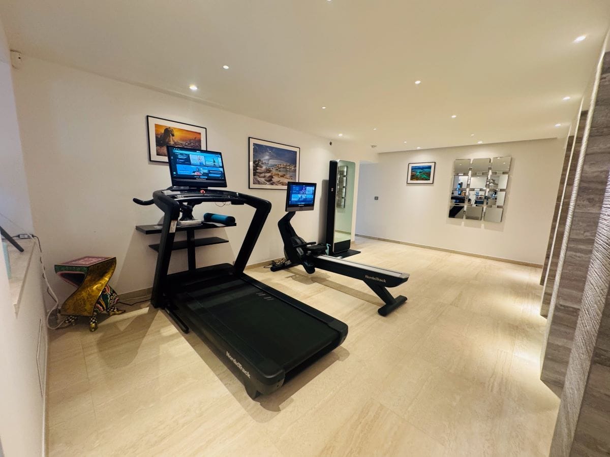 Gym equipped with treadmills in a luxury villa